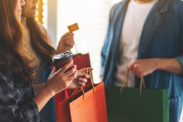istock people with shopping bags holding and using a credit card 1167877752