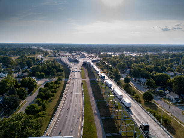 An Aerial View Of A Line Of Semi Trucks Waiting At The Canadian Border To Enter The USA An aerial view of Canada and the United States of semis waiting to cross at The International Border Crossing international border stock pictures, royalty-free photos & images