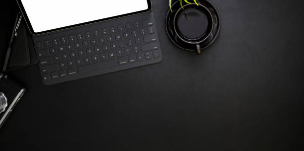 istock Top view of dark modern workplace with office supplies 1167882119