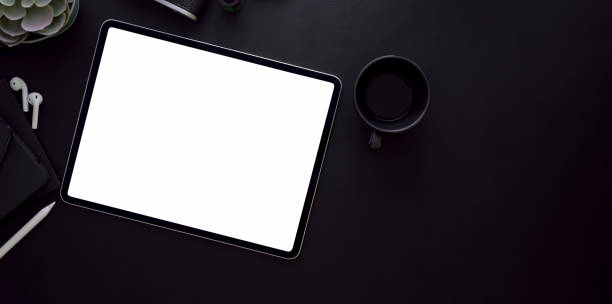 istock Blank screen tablet and coffee cup on black leather desk background i 1167882157