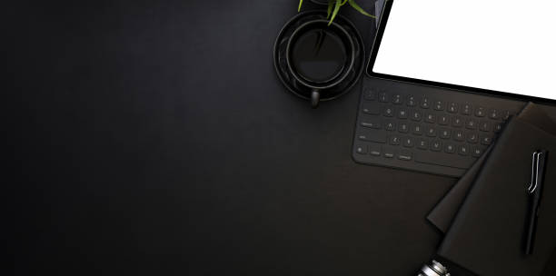 istock Top view of modern workplace with blank screen tablet and cup of coffee 1167882159