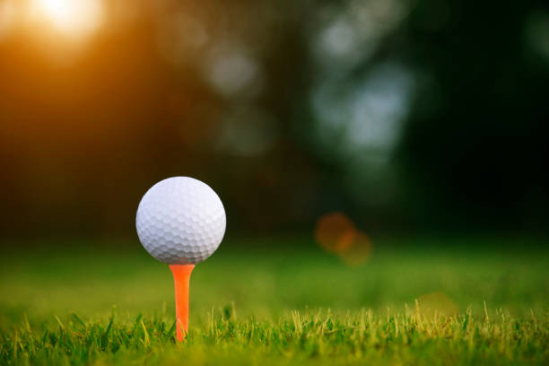 istock golf ball on tee in a beautiful golf course 1167884178