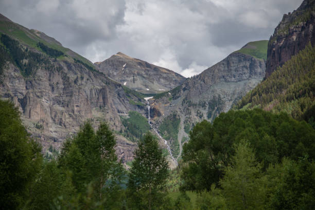 Mountain Waterfall in Spring Cascading Creek - Beautiful views of fresh green aspens and rugged waterfalls in mountain canyons. Landscape scenic nature view.