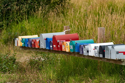 Colorful mailboxes are seen with a grass background.