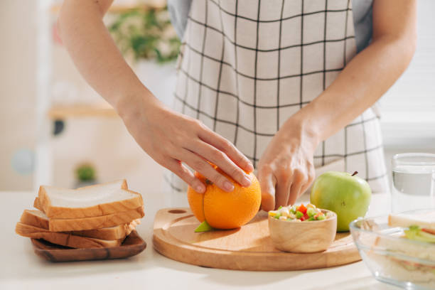 istock Mother preparing school lunch for childrens in home kitchen 1167888931