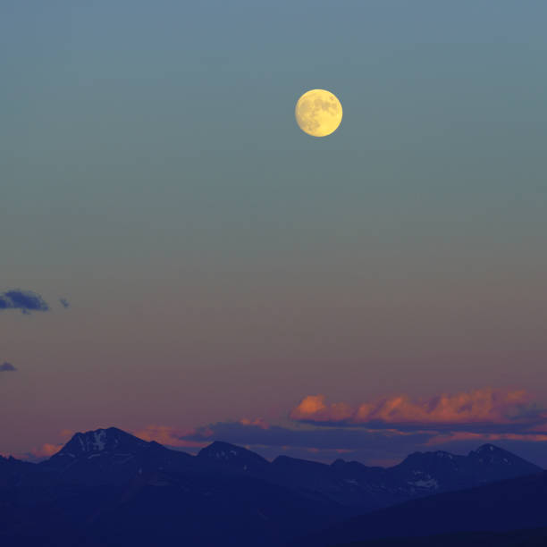 istock Near Full Moon Sunset and Mountains 1167894793