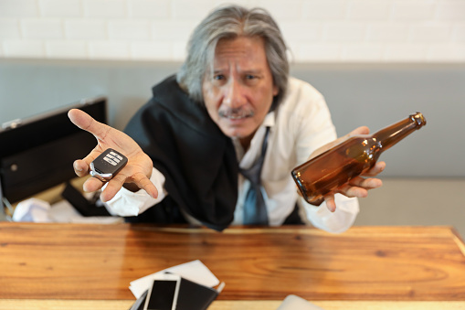 The hand with the smart watch is holding a beer mug, next to the QR code is his cell phone