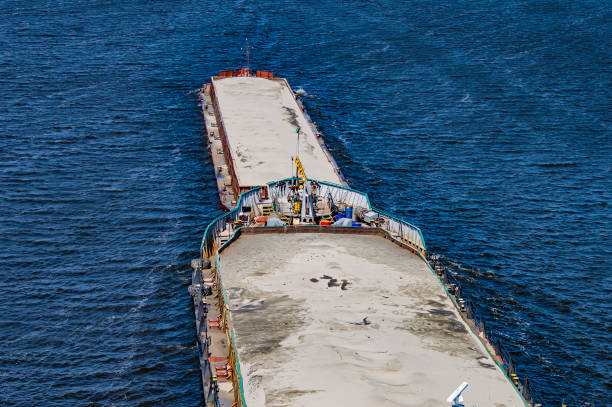 istock Barges loaded with sand floats on the river. 1167896216