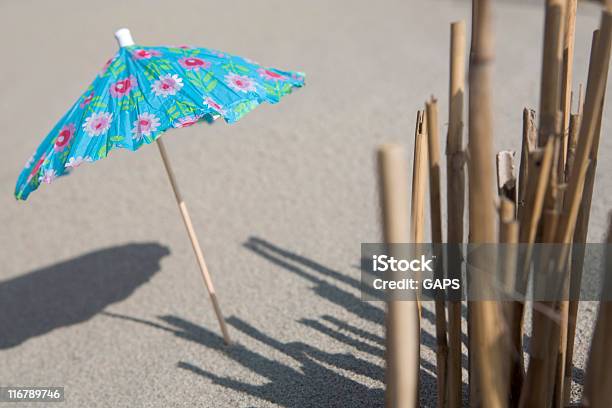 Colorful Cocktail Umbrella In The Sand Stock Photo - Download Image Now - Beach, Cocktail, Cocktail Stick