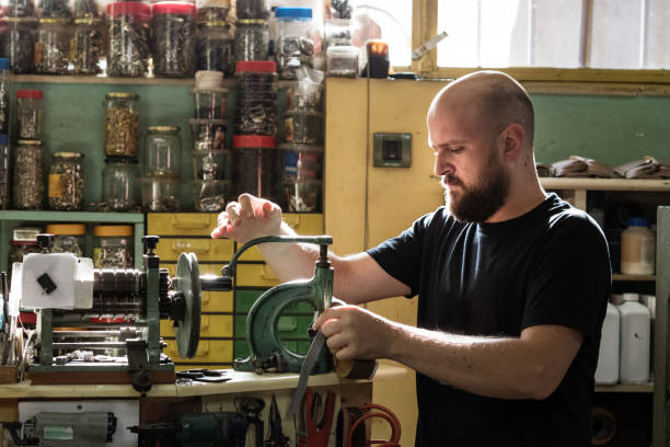 istock A male shoemaker operating an old rivet press machine at his workshop. 1167899934
