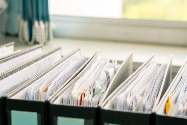 istock row of white paper documents in the black folder on the working office table, report files background with copy space 1167902725