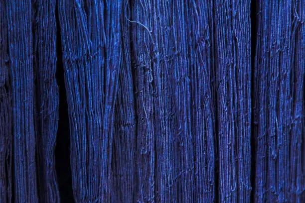 Photo of Natural Indigo dye cotton fabric, Cotton yarn dyed blue nature color, traditional fabrics of thailand, Selective Focus