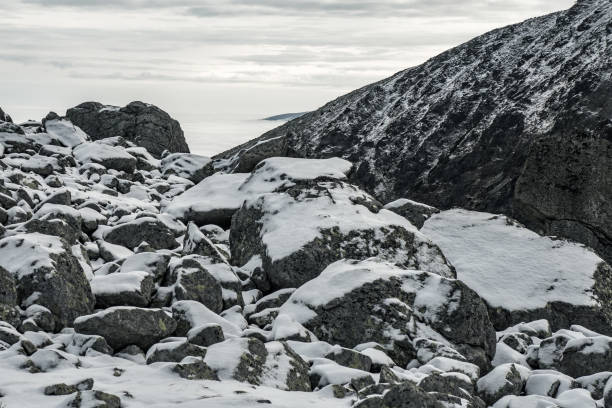 istock Stones in the mountains covered by snow. 1167906798
