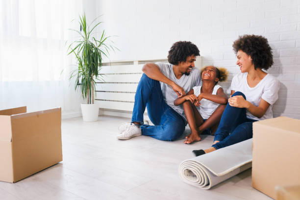 istock Young Happy African-american Family Unpacking During Move 1167906823