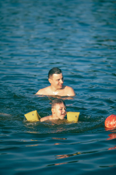 istock father with kid having fun in water swimming together 1167908874