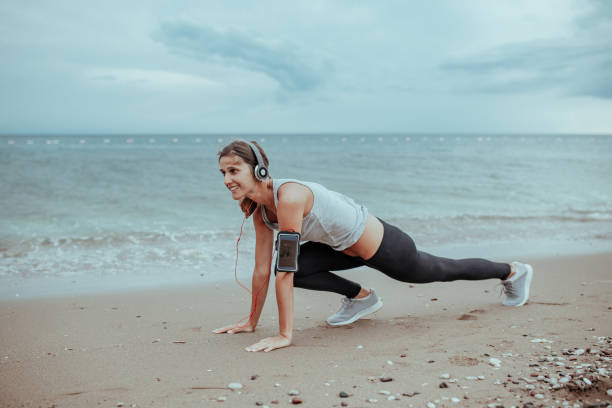 istock Woman is training on the beach 1167910166