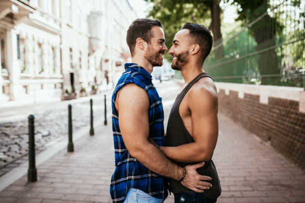 istock Free multi ethnic gay couple hugging in summer. 1167910556