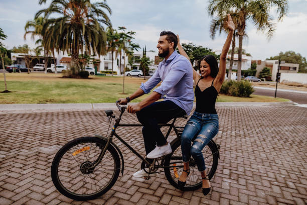 istock Millennial friends riding bicycle on spring day 1167912886