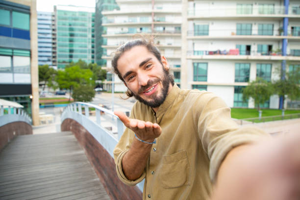 istock Joyful happy hipster guy blowing kiss to camera 1167918571