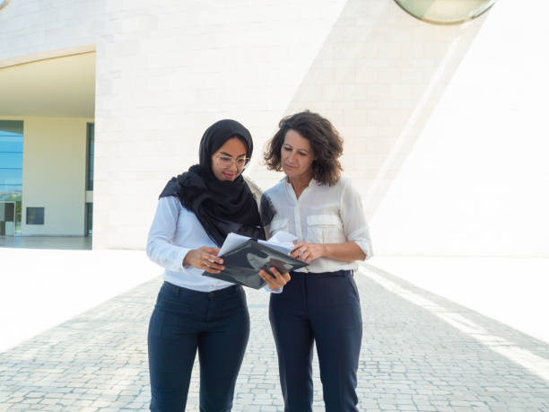 istock Successful female professionals reviewing documents 1167920114