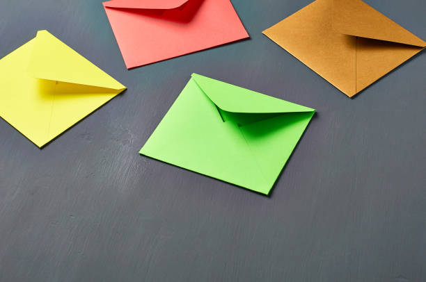 istock Group of colorful square envelopes lies on old scratched dark concrete. Space for text 1167920236
