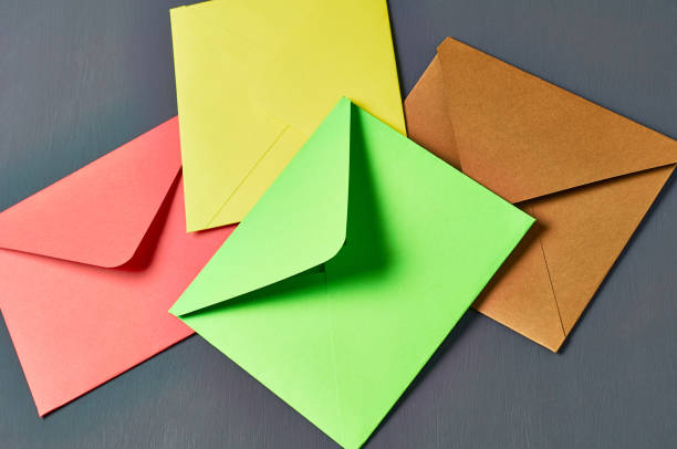 istock Group of colorful square envelopes lies on old scratched dark concrete 1167920251