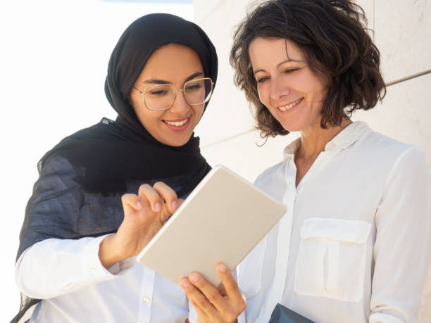 istock Happy multicultural female employees watching presentation 1167920533