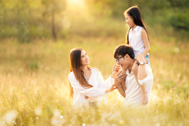asian family father, mother and daughter play togather in the outdoor park - togather imagens e fotografias de stock