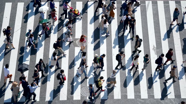 Crowd of People Commuters Walking at Shibuya crossing