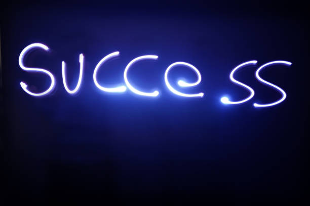 istock Success text written with blue neon lights 1167928194
