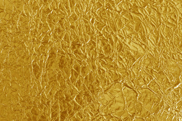 istock Gold foil leaf shiny texture, abstract yellow wrapping paper for background and design art work. 1167928262