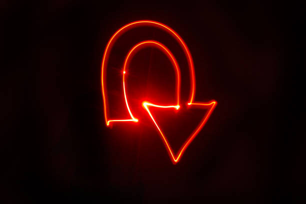 U turn arrow bright red light painting U turn arrow bright red light painting. Studio shot with a black background. Drawn with red LED lights. retractable photos stock pictures, royalty-free photos & images