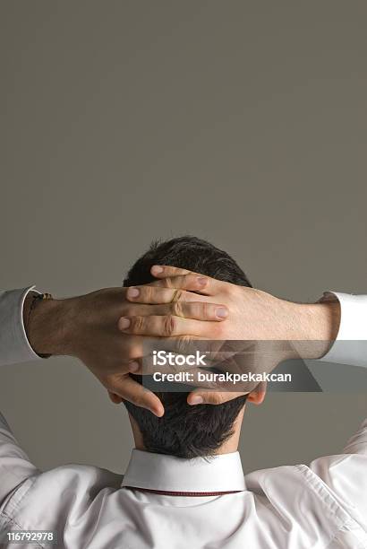 Businessman Relaxing With Hands Behind Head Stock Photo - Download Image Now - 30-39 Years, Achievement, Adult