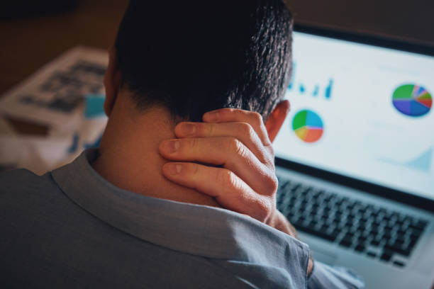 istock Male freelancer working on laptop suffering from neck pain 1167930229