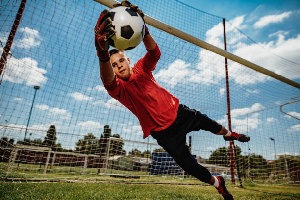 Successful teenager goalkeeper Training of junior team of goalkeepers teen goalie stock pictures, royalty-free photos & images