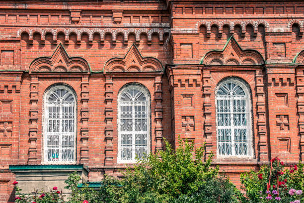 istock Facade of the old brick building with white window shutters. 1167933289