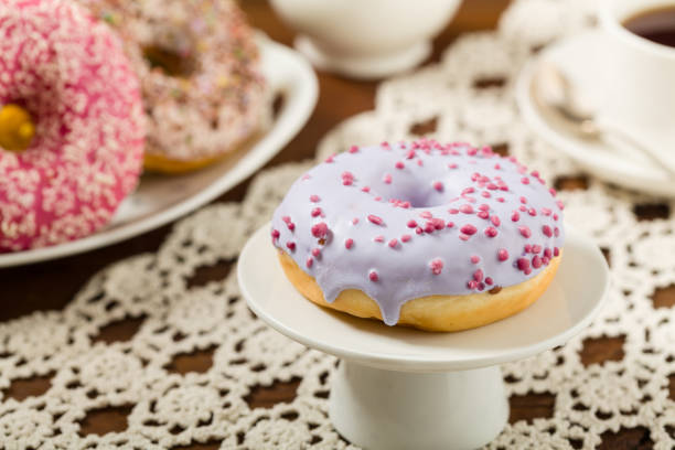 istock Colorful donuts on a wooden background. 1167933658