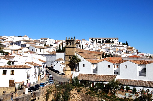 Elevated view across the old bridge towards the old town and the Nuestro Padre Jesus church, Ronda, Malaga Province, Andalucia, Spain, Europe.