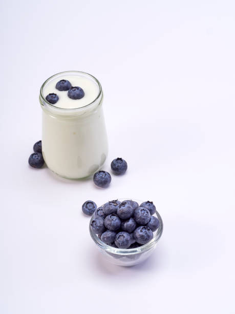 istock White yogurt and blueberry in a glass on a white background. 1167934152