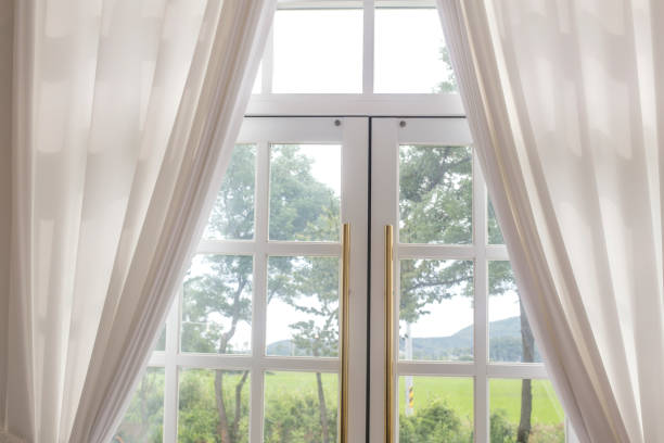 istock White curtain and garden looking out the window 1167936808