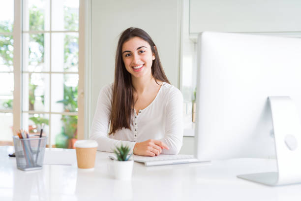 istock Beautiful young woman working using computer with a happy and cool smile on face. Lucky person. 1167937570