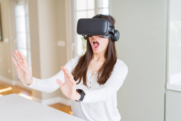 istock Young woman playing virtual reality game using simulation glasses headset, funny and amazing entertainment 1167937755