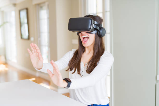 istock Young woman playing virtual reality game using simulation glasses headset, funny and amazing entertainment 1167937858