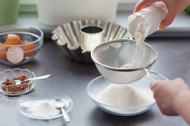 istock Baking cake. Next stages, following stages. We sift the flour. 1167939153