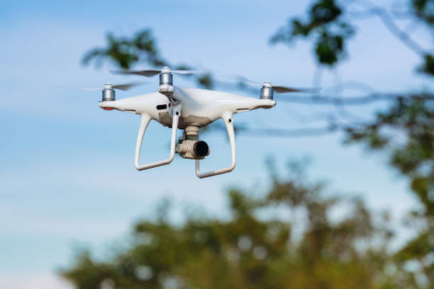 DJI Phantom quadcopter drone flight in summer blue sky and takes pictures stock photo