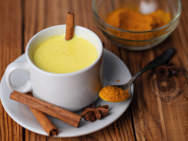 istock Golden milk with turmeric on wooden table 1167939391