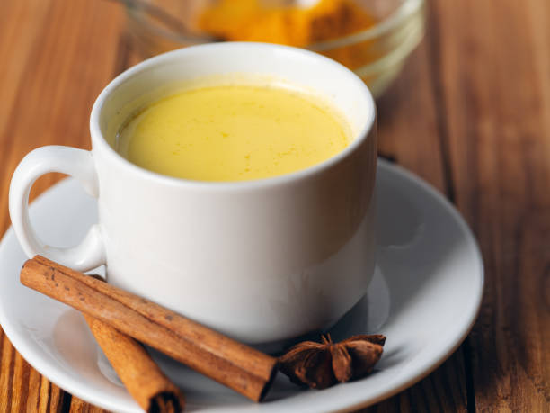 istock Golden milk with turmeric on wooden table 1167939395