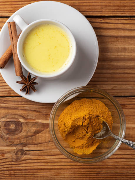 istock Golden milk with turmeric on wooden table 1167939396