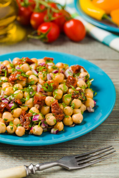 istock Chickpeas salad with onion and dried tomatoes. 1167940452