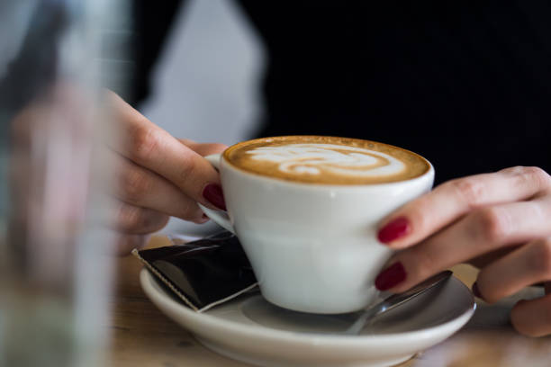 istock Women holding a cup of hot latte 1167943331